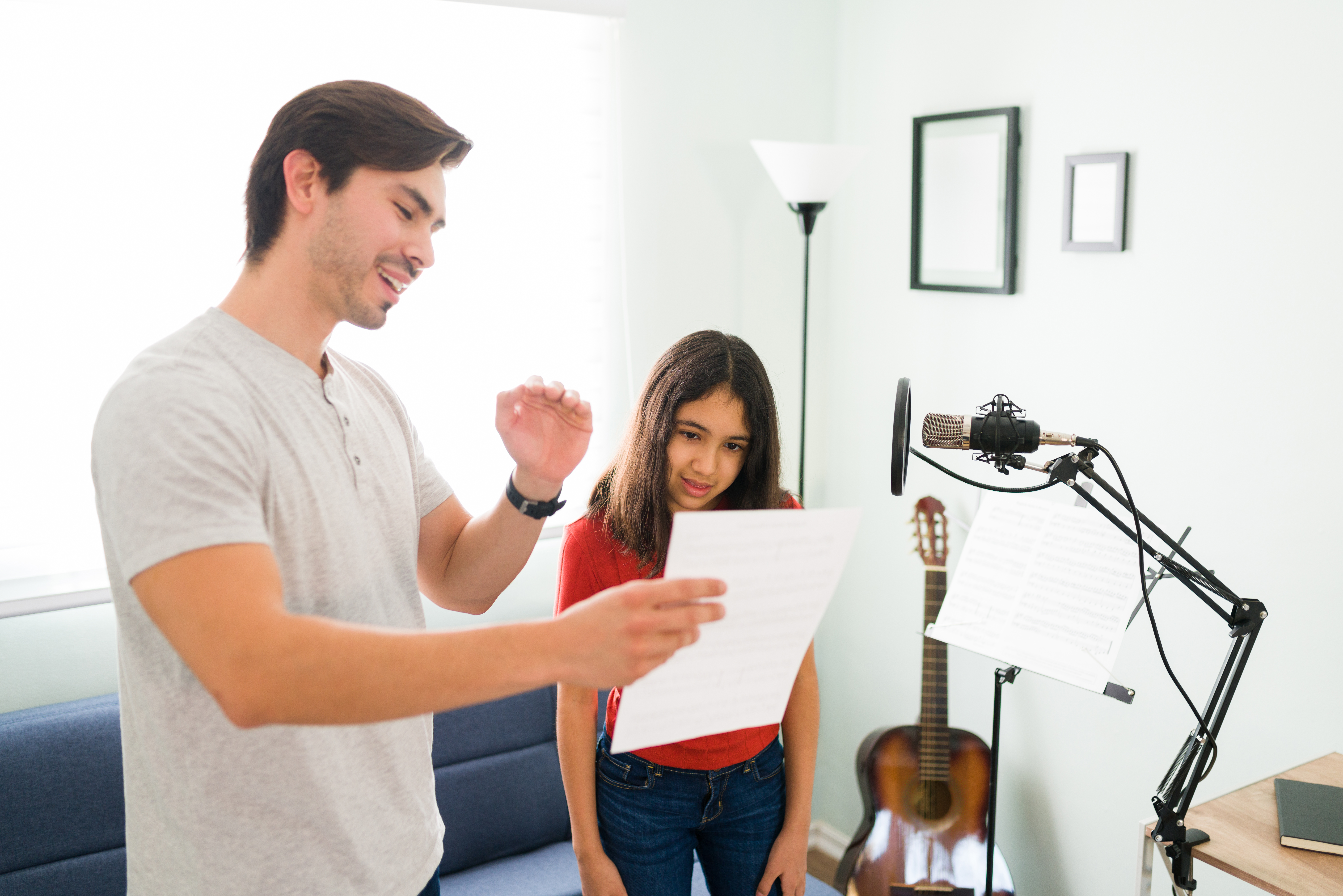 Handsome instructor singing a song to his student
